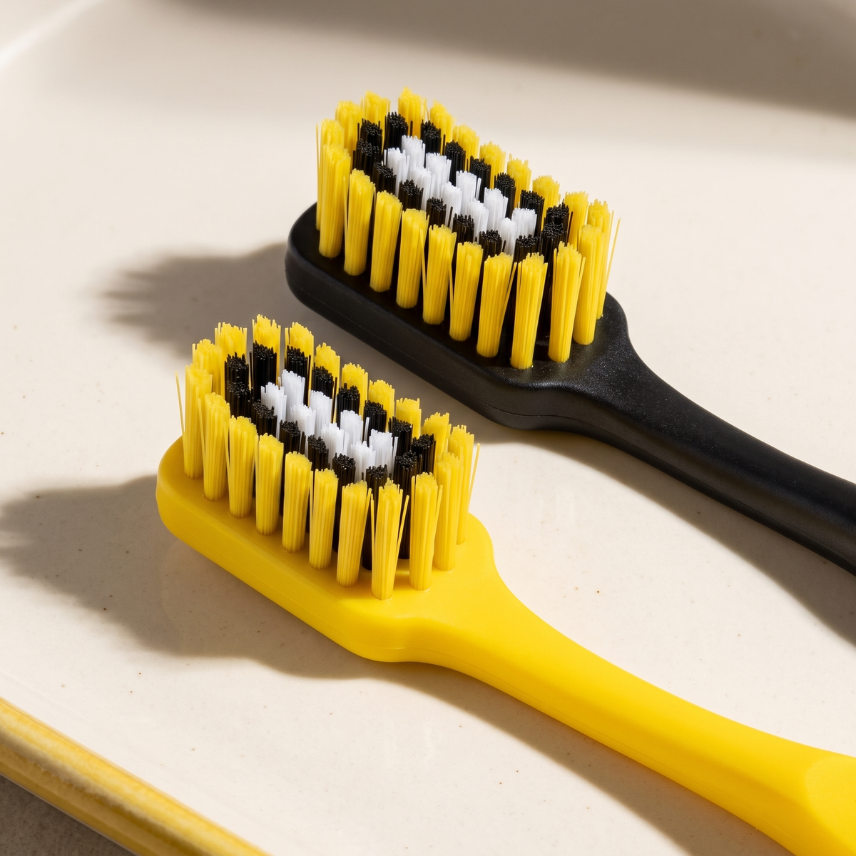 Detail of yellow and black Stadium toothbrush heads.
